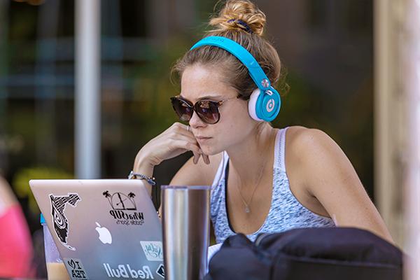 Student studying with headphones on